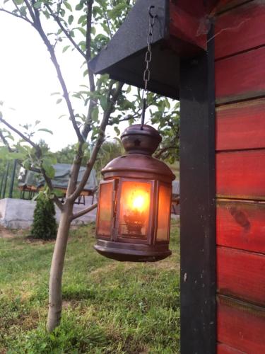 a lantern hanging from the side of a house at Seosko domacinstvo Becirovic - Kukulik lodgings in Bijelo Polje