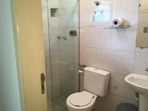 a bathroom with a shower and a toilet and a sink at Hostel Rotor in Ouro Branco
