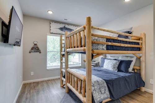 a bedroom with a bunk bed and a tv at NEW 3 BR Apartment Sleeps 6 in Pigeon Forge