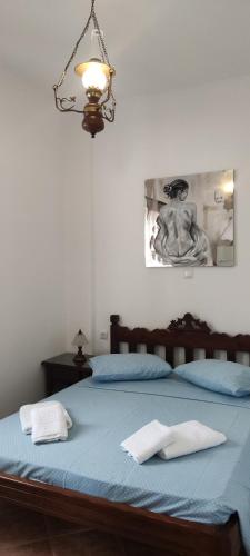 a bedroom with a bed with two towels on it at Chrysiis House 1 in Maltezana
