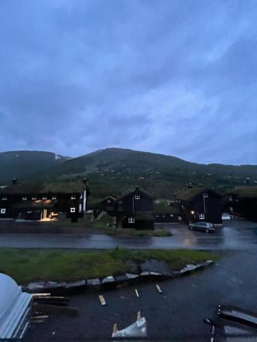 a view of a parking lot with mountains in the background at Resvegen 63 in Stranda