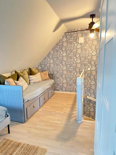 a living room with a couch in a attic at New Åkrahamn coast house in Sæveland