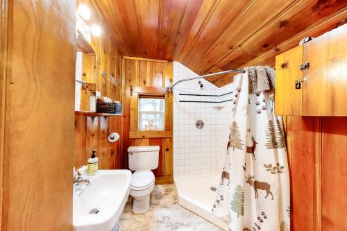 a bathroom with a tub and a toilet and a shower curtain at Mount Bonneville in Joseph