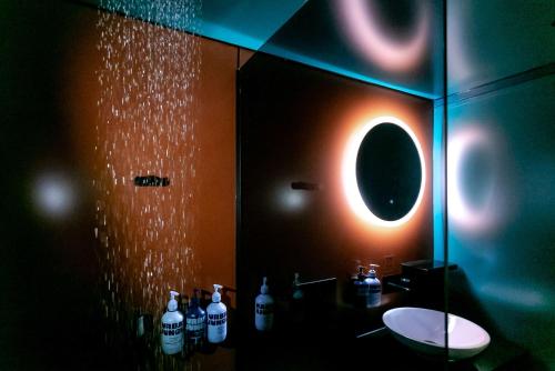 a bathroom with a sink and a mirror at YOTEL Manchester Deansgate in Manchester