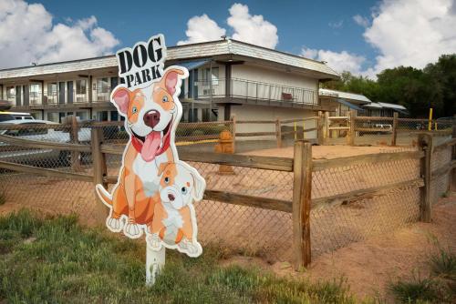 a sign for a dog park in front of a building at Studio 6 Grand Junction, CO in Grand Junction