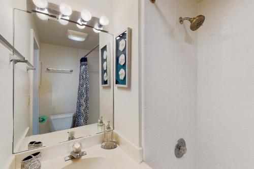a bathroom with a sink and a shower and a mirror at Sealoft 2032 in Hilton Head Island