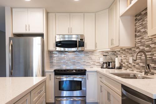 a kitchen with white cabinets and a stainless steel appliance at 126 Hale Kamaole in Wailea
