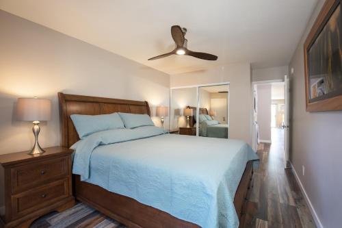 a bedroom with a bed and a ceiling fan at 126 Hale Kamaole in Wailea