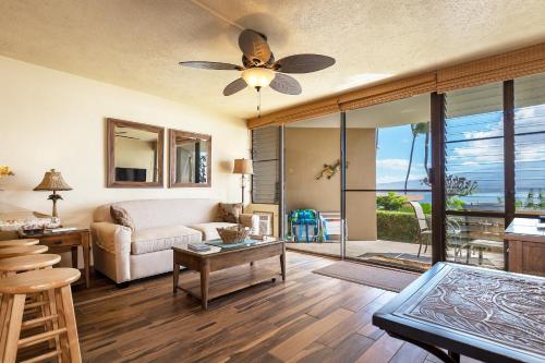 a living room with a couch and a ceiling fan at 106 Milowai in Wailuku