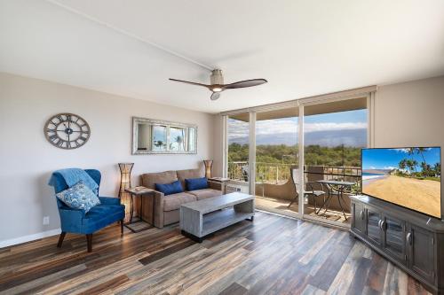 a living room with a couch and a tv at 401 Nani Kai HaleBeachfrontNewly Remodeled in Kihei