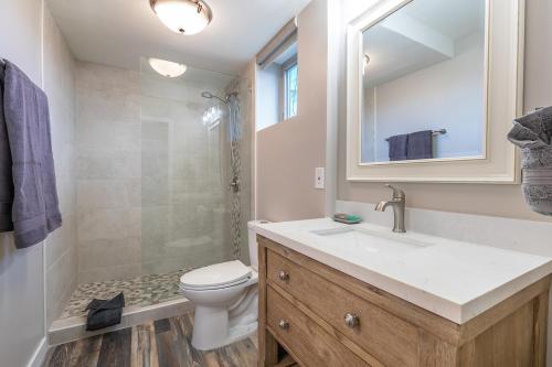 a bathroom with a sink and a toilet and a shower at 401 Nani Kai HaleBeachfrontNewly Remodeled in Kihei