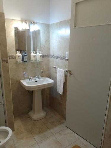 a bathroom with a sink and a toilet at Departamento Plaza in Bahía Blanca