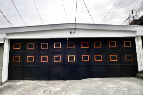 una puerta de garaje con cuadrados de naranja. en Casa Xunaan Kab, en San Salvador