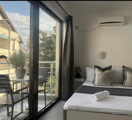 a bedroom with a bed and a balcony at Apartments Villa Stefan in Budva