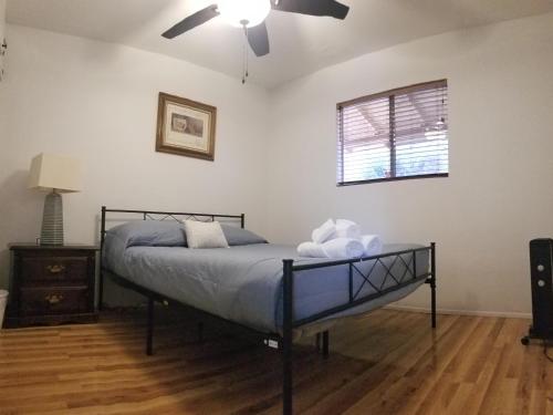 a bedroom with a bed and a ceiling fan at 3BR Panoramic Lake View, Sequoia Forest, Kern County in Wofford Heights