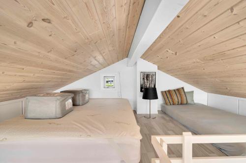 a bedroom with a bed and a wooden ceiling at Holiday Home In Karrebæksminde Near The Beach in Karrebæksminde