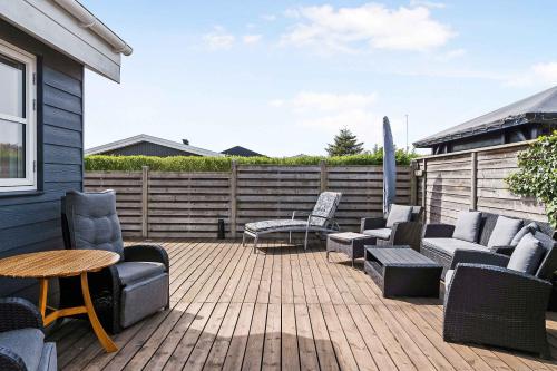 a patio with chairs and tables and a fence at Holiday Home In Karrebæksminde Near The Beach in Karrebæksminde