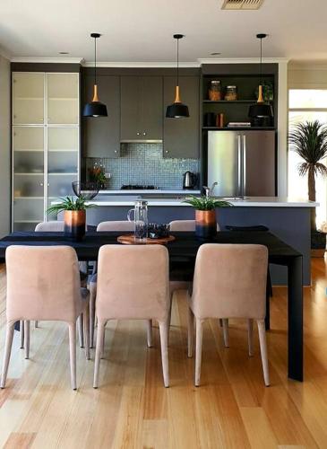 a kitchen with a table and chairs in a kitchen at Luxurious beach stay, nearby famous wineries in Aldinga Beach