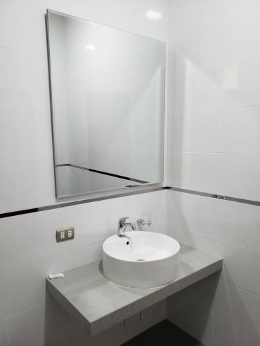 a bathroom with a sink and a large mirror at Condominio La Curva in Churín