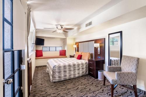 a hotel room with a bed and a chair at Scottsdale Camelback Resort in Scottsdale