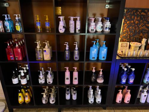 a shelf filled with lots of different colored bottles at HOTEL Iz bayside 大人専用 in Funabashi