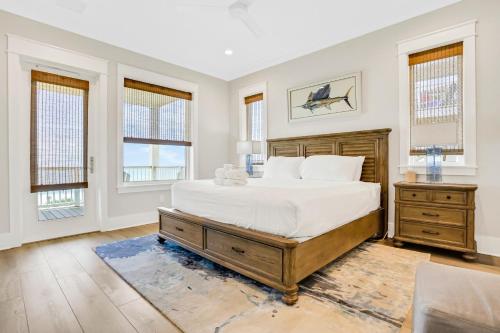 a bedroom with a large bed and two windows at Macon Memories in St. George Island