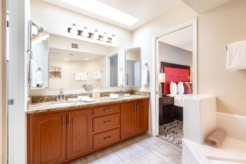 a bathroom with two sinks and a large mirror at Scottsdale Camelback Resort in Scottsdale