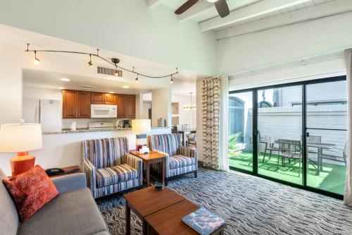 a living room with a couch and chairs and a kitchen at Scottsdale Camelback Resort in Scottsdale