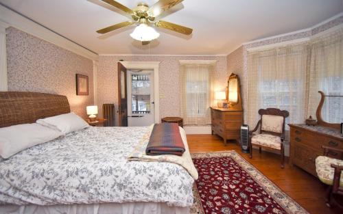 a bedroom with a bed and a ceiling fan at Blooming Inn Shelburne Falls in Shelburne Falls