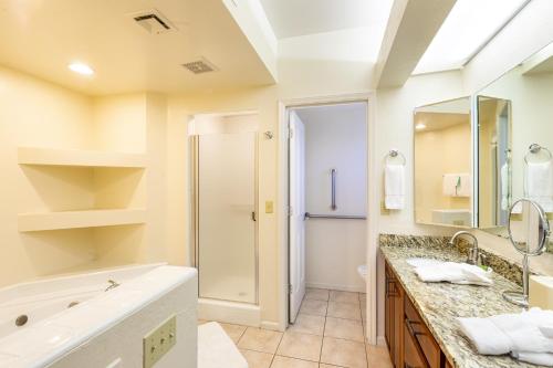 a bathroom with a large tub and a sink at Scottsdale Camelback Resort in Scottsdale