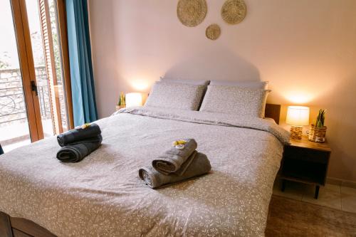 a bedroom with a bed with two towels on it at Morpheus Realm Apartment in Ioannina