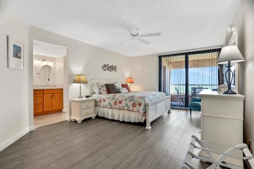 a bedroom with a bed and a bathroom with a window at Crescent Beach Club I 4G in Clearwater Beach