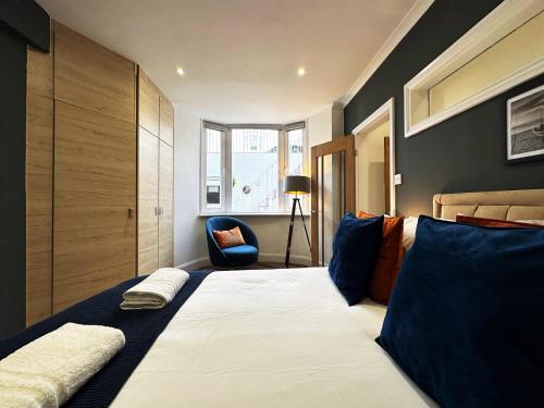a bedroom with a large bed and a chair at Liam's Place near Hyde Park in London