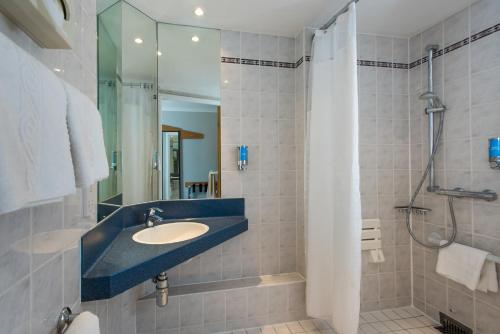 a bathroom with a sink and a shower at Holiday Inn Express - Glasgow - City Ctr Riverside, an IHG Hotel in Glasgow