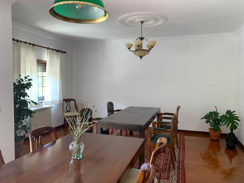 a dining room with a wooden table and chairs at Casa Pedravedra in Mondim de Basto