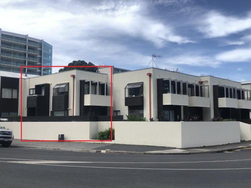 a building on the side of a street at The Bay The Beach The Mount The Best in Mount Maunganui