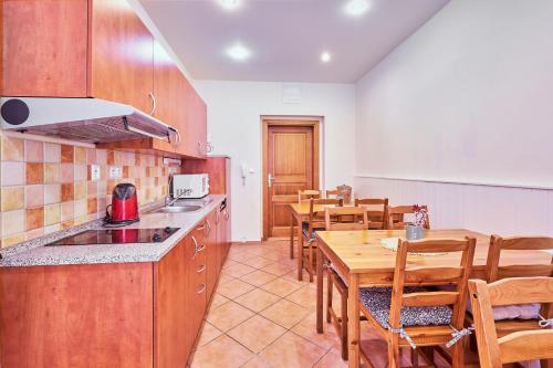 a kitchen and dining room with a table and chairs at Penzion Weber in Český Krumlov