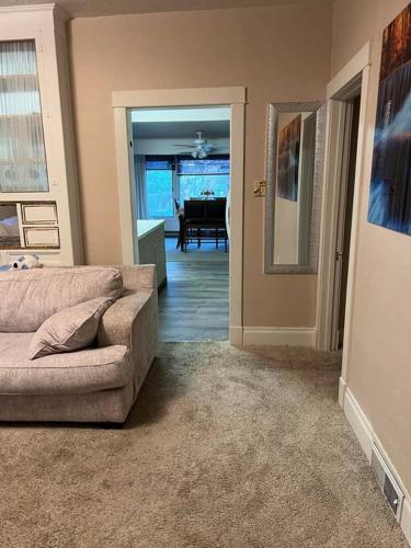 a living room with a couch and a dining room at Bel apartment in Sioux City