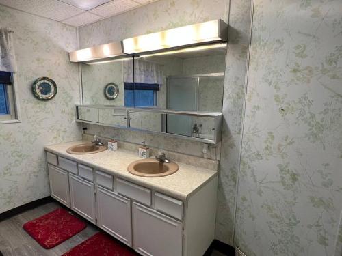 a bathroom with two sinks and a mirror at Bel apartment in Sioux City