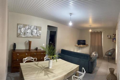 a living room with a blue couch and a table at VILLA CAPACITE 6 PERSONNES PROCHE PLAGES DU Sud in Rivière-Pilote