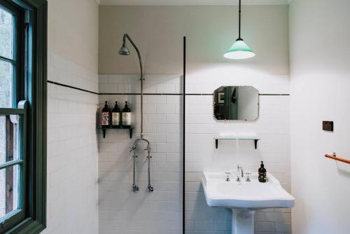 a bathroom with a sink and a shower at Black Springs - A Romantic Bushland Escape in Mudgee