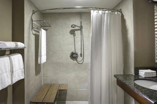 a bathroom with a shower and a sink at Sheraton Oklahoma City Downtown Hotel in Oklahoma City