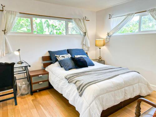 a bedroom with a large bed with blue pillows at Charming 3BR House - Hal-UC in Los Angeles
