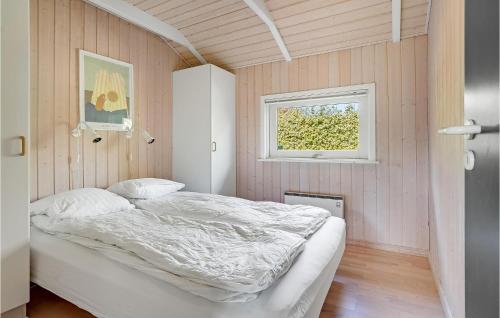 a bedroom with a bed in a room with a window at Lovely Home In Hejls With Sauna in Hejls