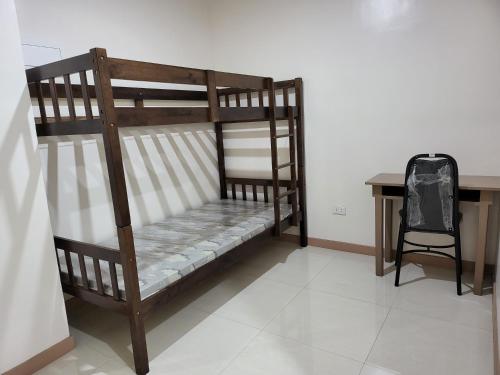 a couple of bunk beds in a room with a desk at Dormitory near SM and S and R in Davao City
