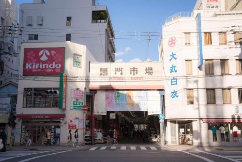 a busy city street with buildings and a crosswalk at 川HOUSE黒門 in Osaka