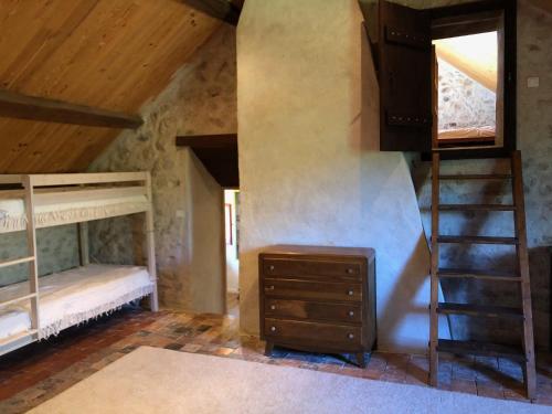 a attic room with bunk beds and a staircase at Grande maison familiale, rustique et charmante en Bourgogne, dans le Morvan in Dun-sur-Grandry