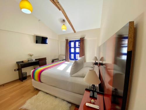 a bedroom with a large bed and a window at Mistico San Blas Boutique in Cusco