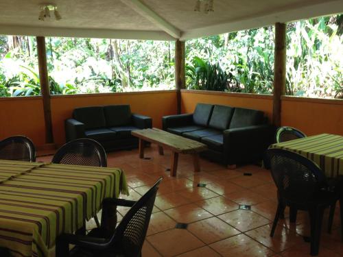 a living room filled with furniture and a table at Reserva Natural Atitlan in Panajachel