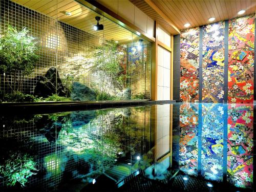 a room with a pool of water and a mosaic wall at Daiwa Roynet Hotel KANAZAWA-MIYABI in Kanazawa